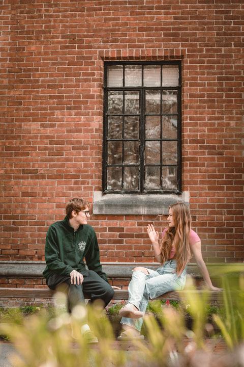 students chatting on bench